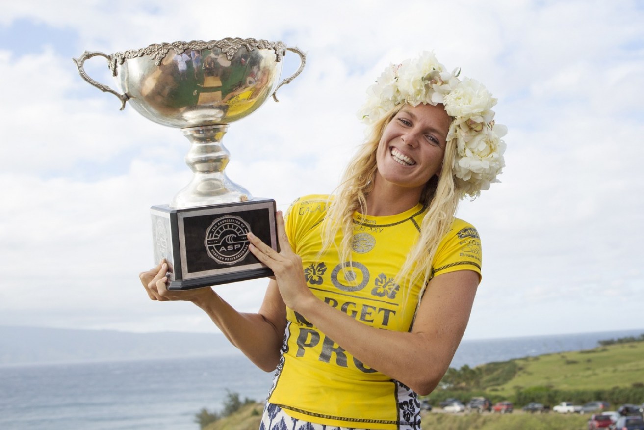 Stephanie Gilmore poses with her most recent surfing world championship trophy in 2014. 