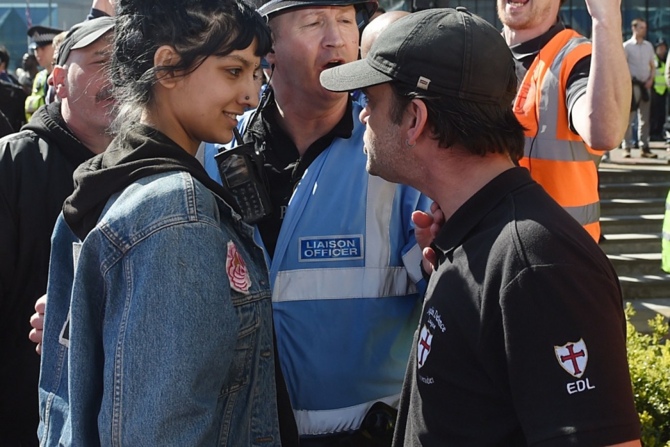 Saffiyah Khan (left) staring down English Defence League protester Ian Crossland at a Birmingham demonstration.