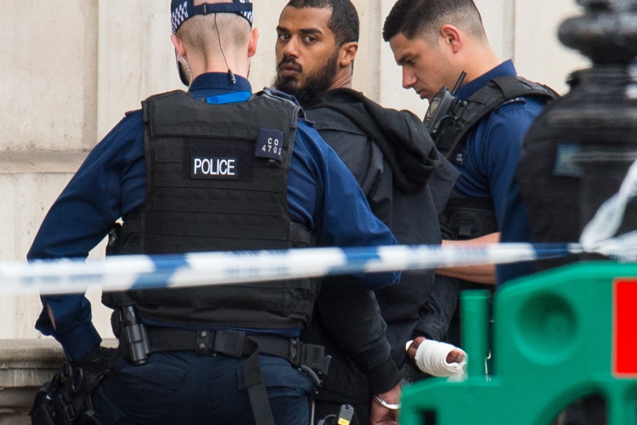 Police have arrested a man allegedly armed with knives near the home of the British PM.