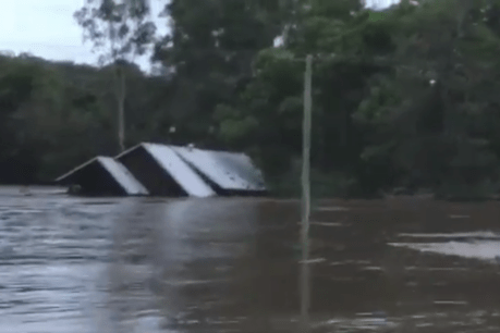 Floodwaters sweep away house minutes after family rescued from roof