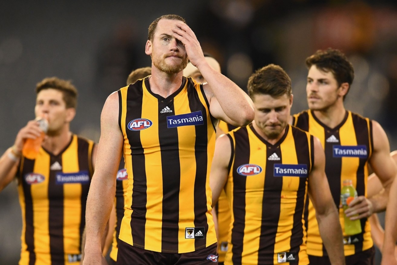 How the mighty have fallen. Hawks skipper Jarryd Roughead ponders defeat against the Cats.