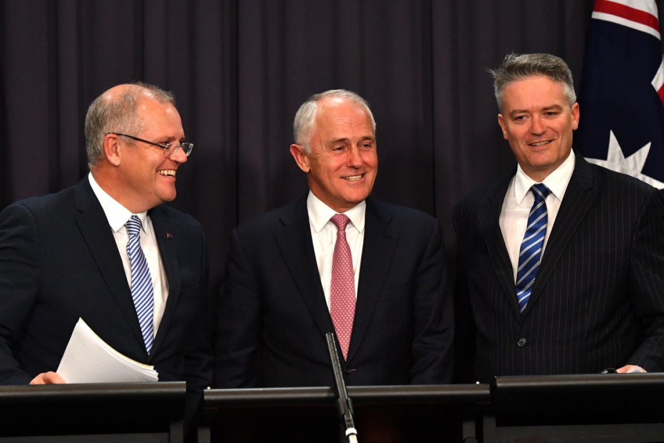 Cheshire cats: Scott Morrison, Malcolm Turnbull and Mathias Cormann spruiking the government's tax cuts.