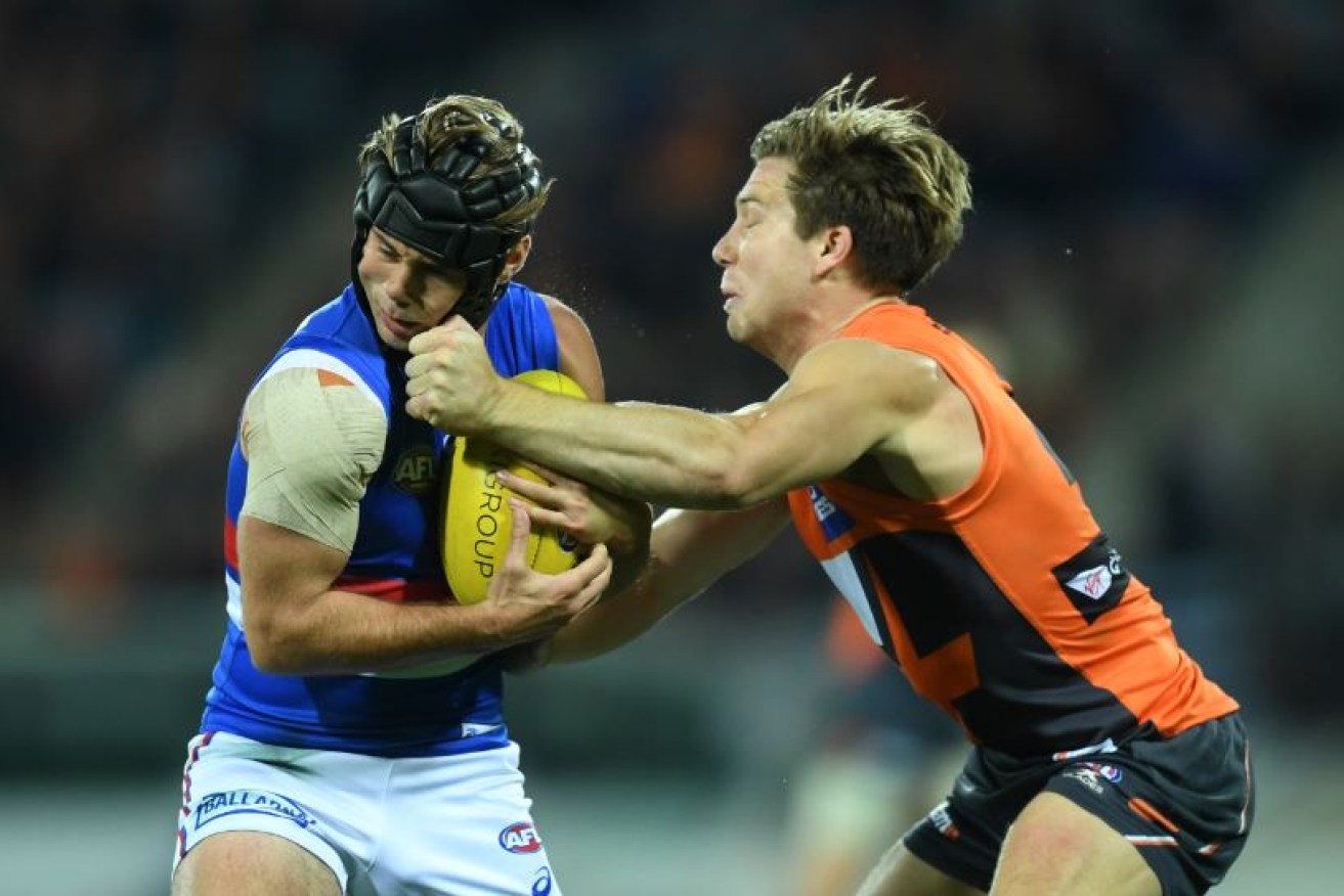 The Bulldogs' mighty mite Caleb Daniel cops a bunch of fives from GWS Toby Greene, who was reported for striking.