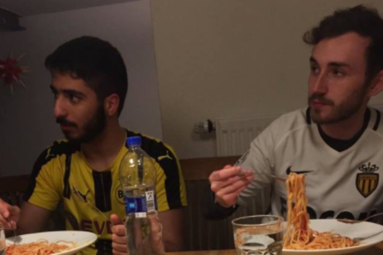 Fans of Dortmund and Monaco share a meal.
