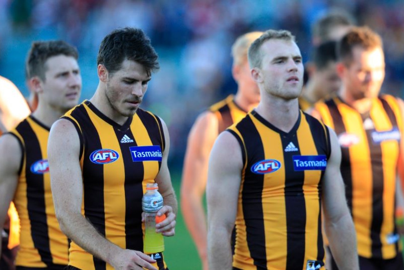 No smiles and nothing to smile about as the Hawks leave the field after their humiliation at the hands of St Kilda .