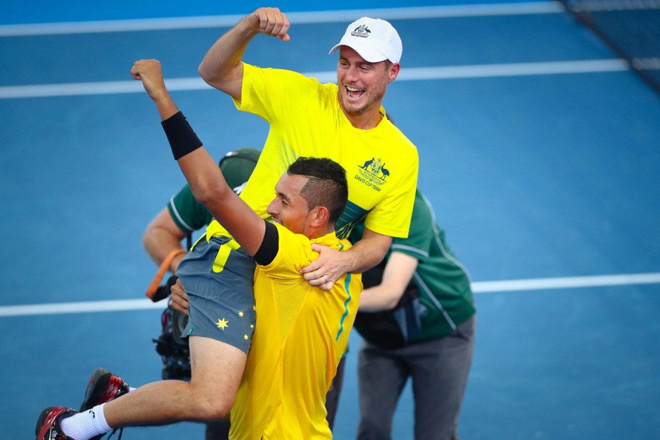 Hewitt and Kyrgios embrace after Australia's recent Davis Cup success.