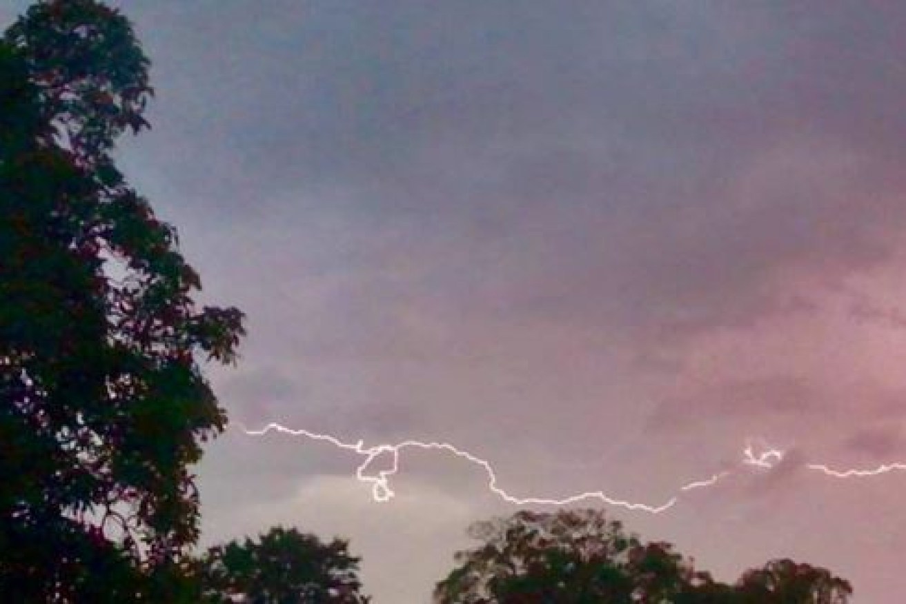 Lightning arcs across the sky as the storm that left at least 14,000 homes without power lashes Melbourne.