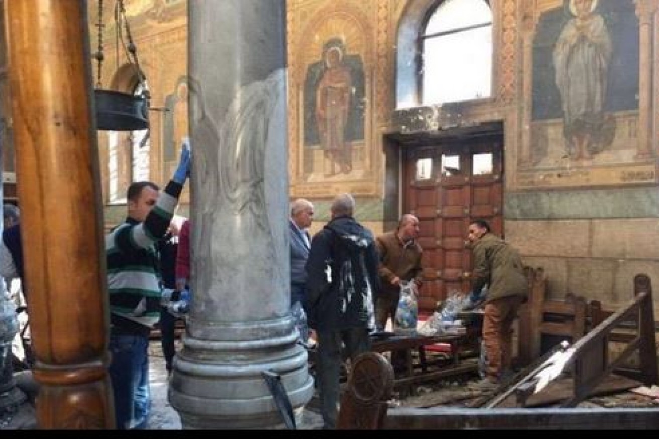 Stunned survivors survey the damage after a blast killed at least 25 Christians attending a Palm Sunday service in the Church of St George in Tanta, north of Cairo. 