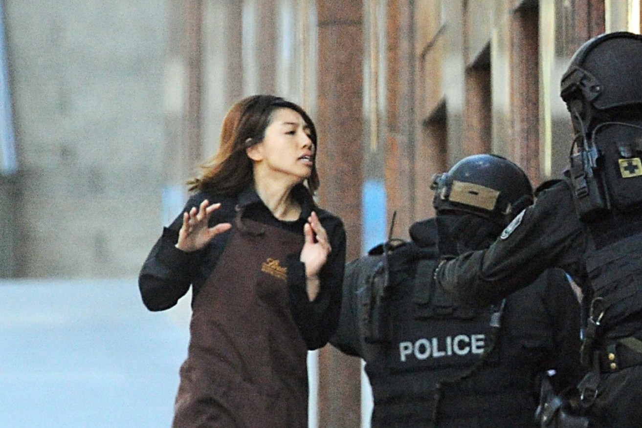 A hostage runs to safety during the Sydney Lindt Cafe siege in 2014.