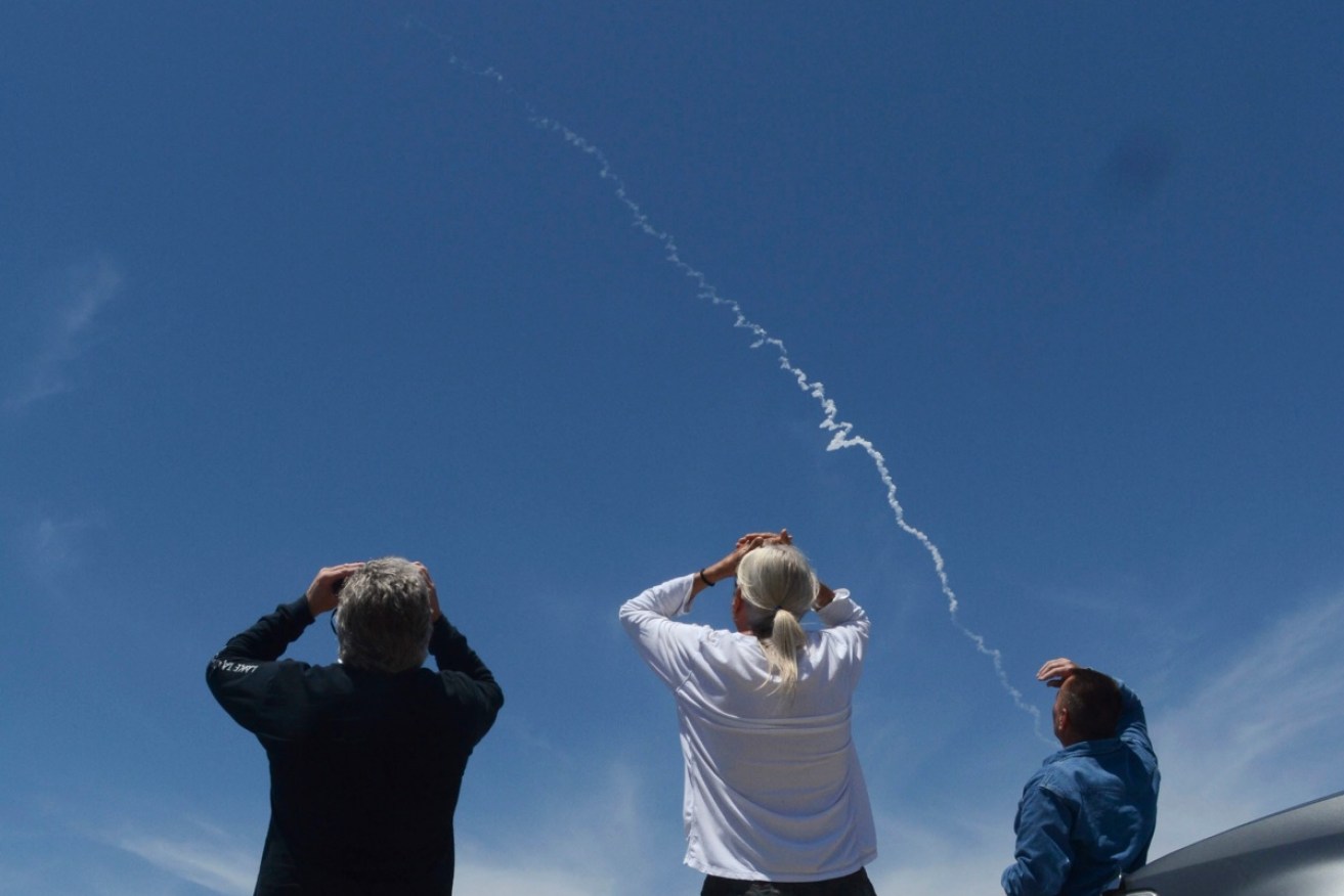 Spectators watch the first-ever launch of an an interceptor missile launch from an underground silo at Vandenberg Air Force Base.