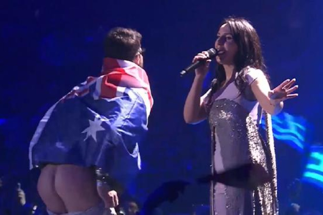 The Eurovision prankster wearing an Australian flag moons the crowd.