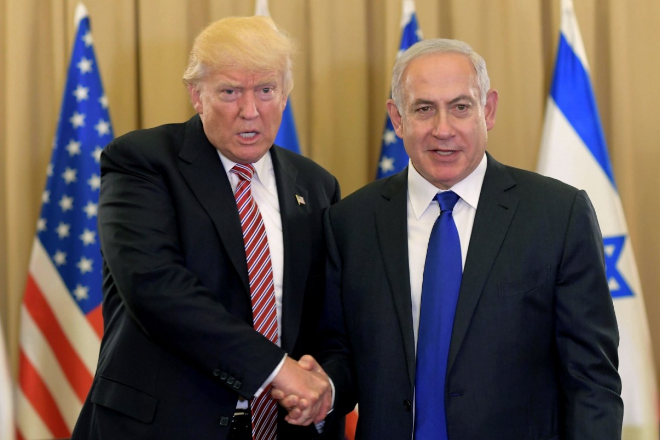 Presiodent Trump treats Benjamin Netanyahu to one of his trademark handshakes.