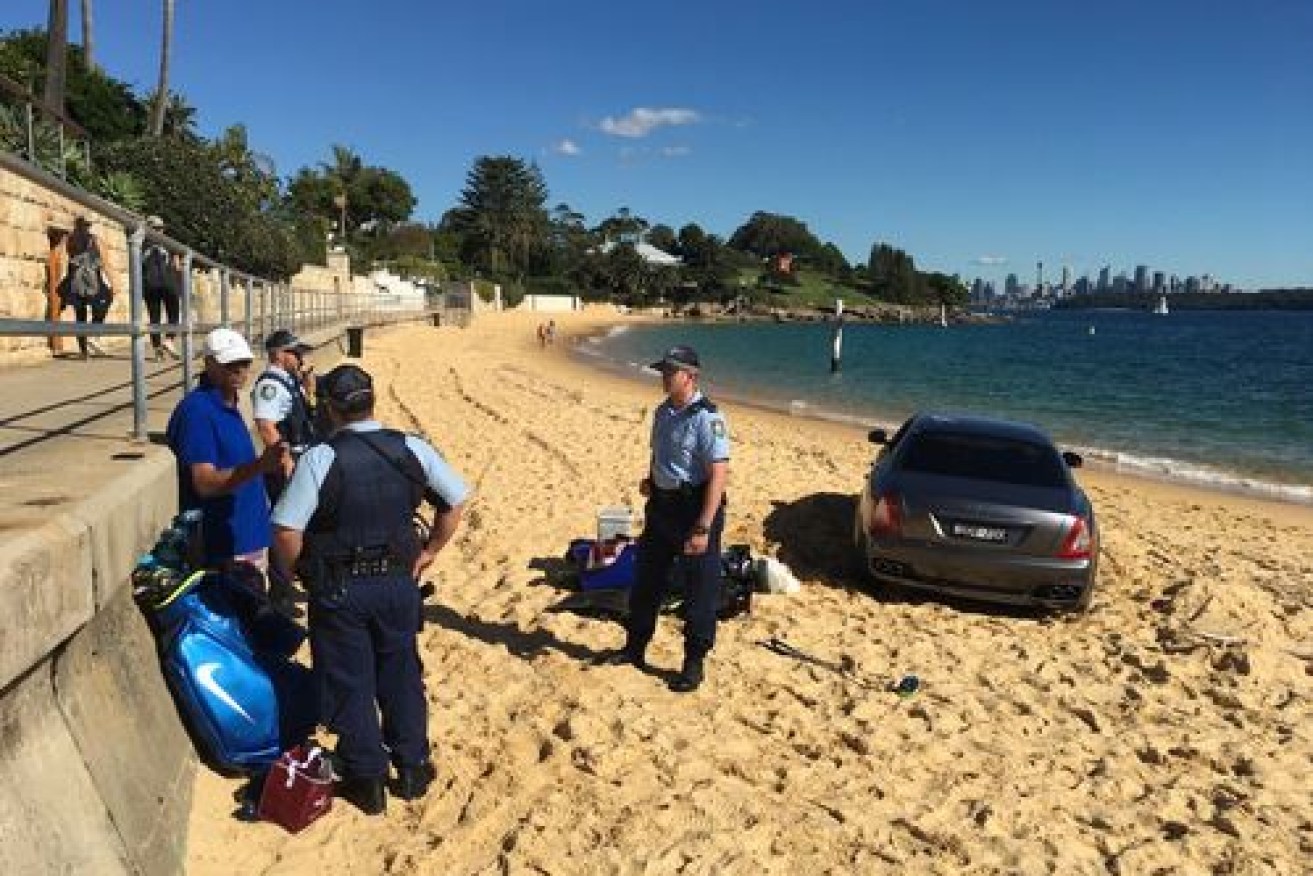 The Maserati sits in Camp Cove's sand trap while police chat with the driver who left it there.