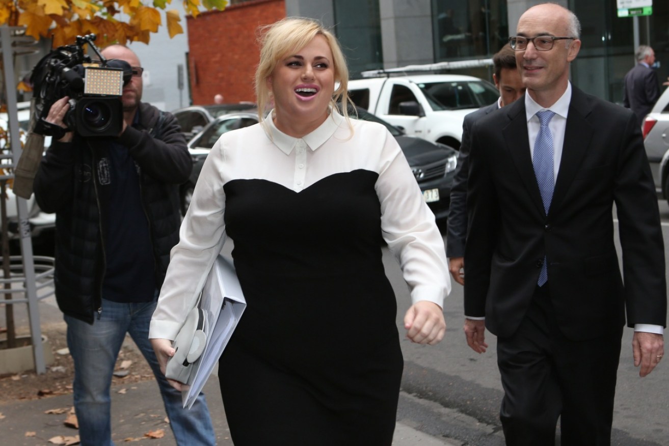 Rebel Wilson arrives at the Supreme Court in Melbourne with her lawyer. 