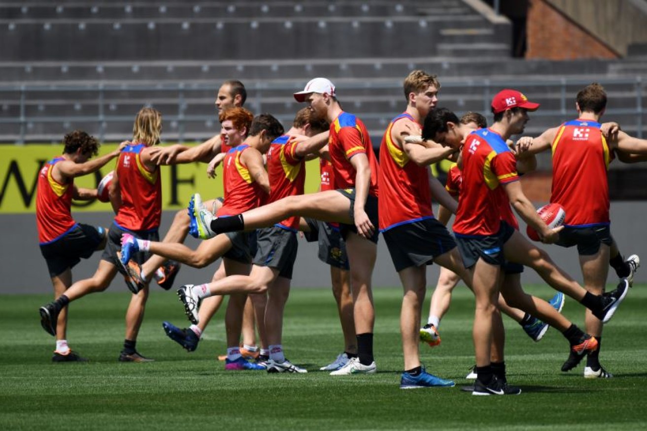 The Gold Coast Suns limber up in preparation for tomorrow's big game in Shanghai.