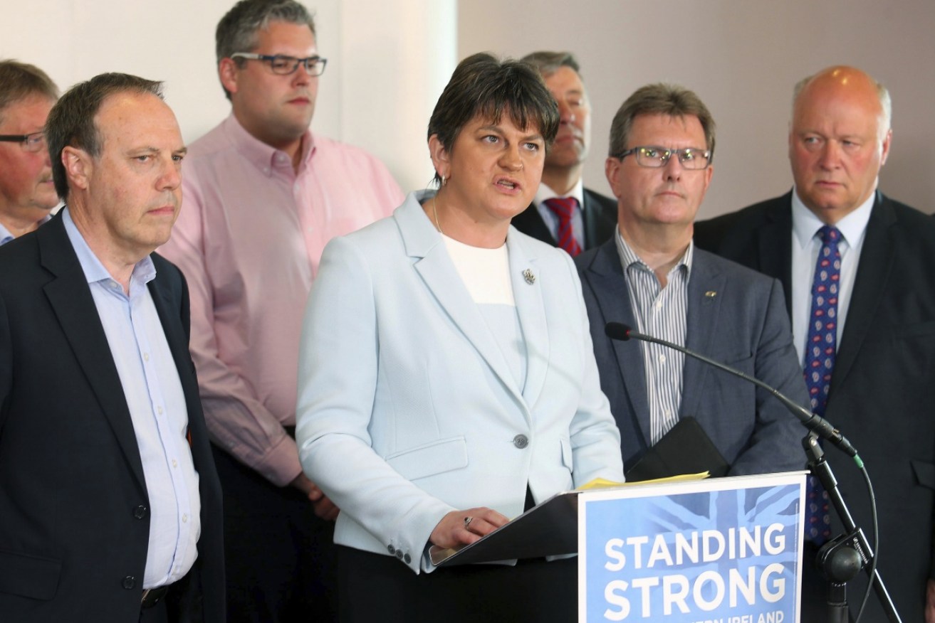 Democratic Unionist Party leader Arlene Foster surrounded by her party Members of Parliament.