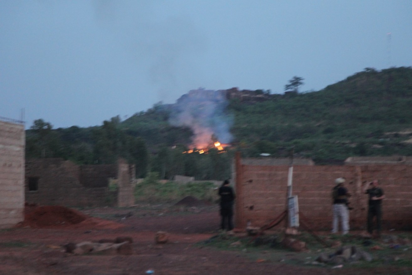 Fire can be seen by the swimming pool of the Campement Kangaba, a tourist resort near Bamako, Mali.