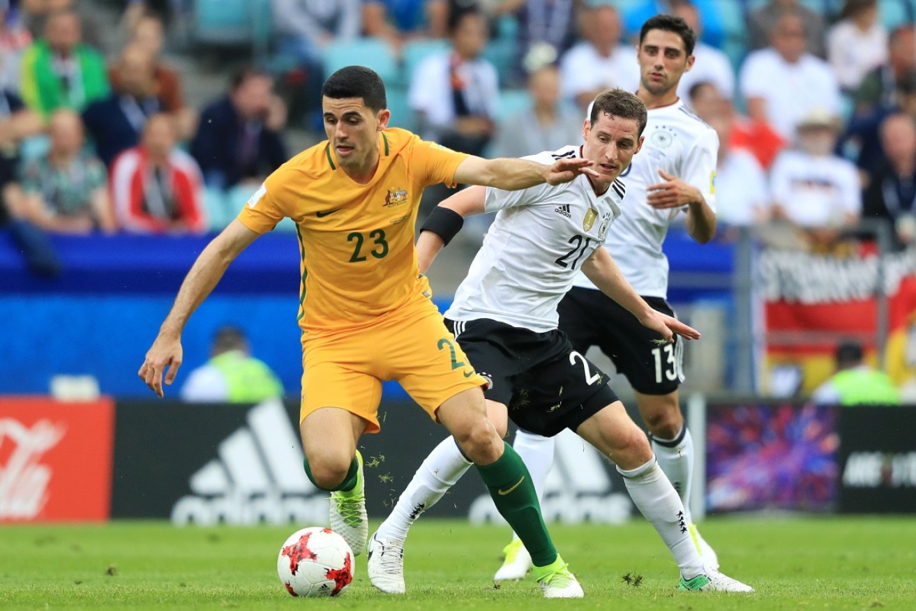 Australia's Tom Rogic (L) and Germany's Sebastian Rudy in action.