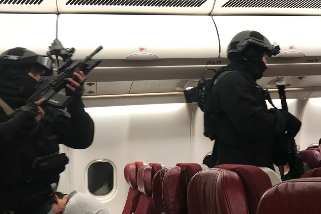 The passenger was restrained by the time police entered the plane.