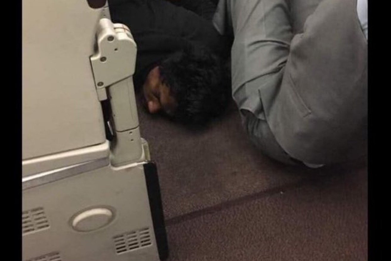 The man who terrified the Malaysian Airlines was subdued by fellow passengers.