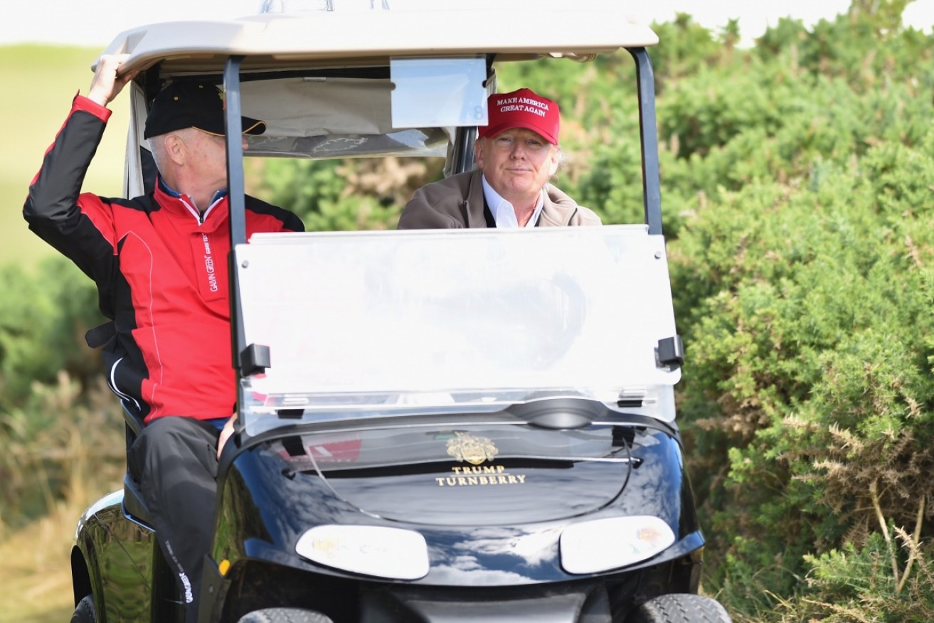US President Donald Trump appears unfazed by North Korea comments, committing a golf etiquette atrocity.