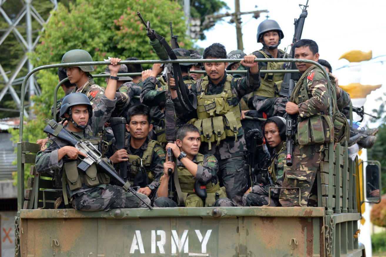 Members of the Philippine police special action force on their way to the frontline in Marawi on June 19, as the armed conflict between government troops and Islamist militants continues