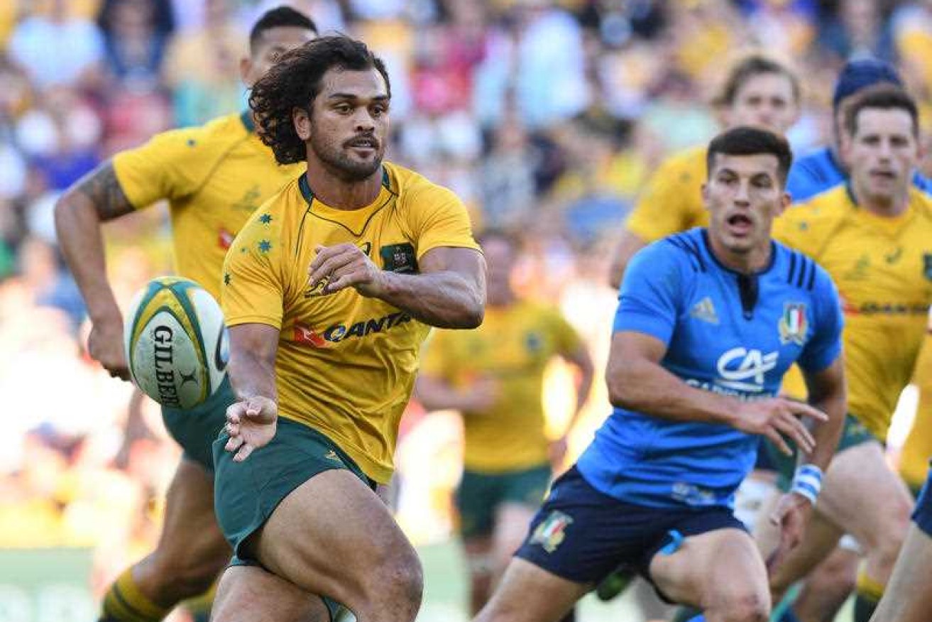 Karmichael Hunt passes the ball during the Wallabies' win over Italy.