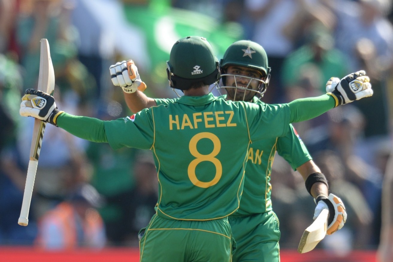 Babar Azam and Mohammad Hafeez of Pakistan embrace after winning the ICC Champions Trophy match against England.