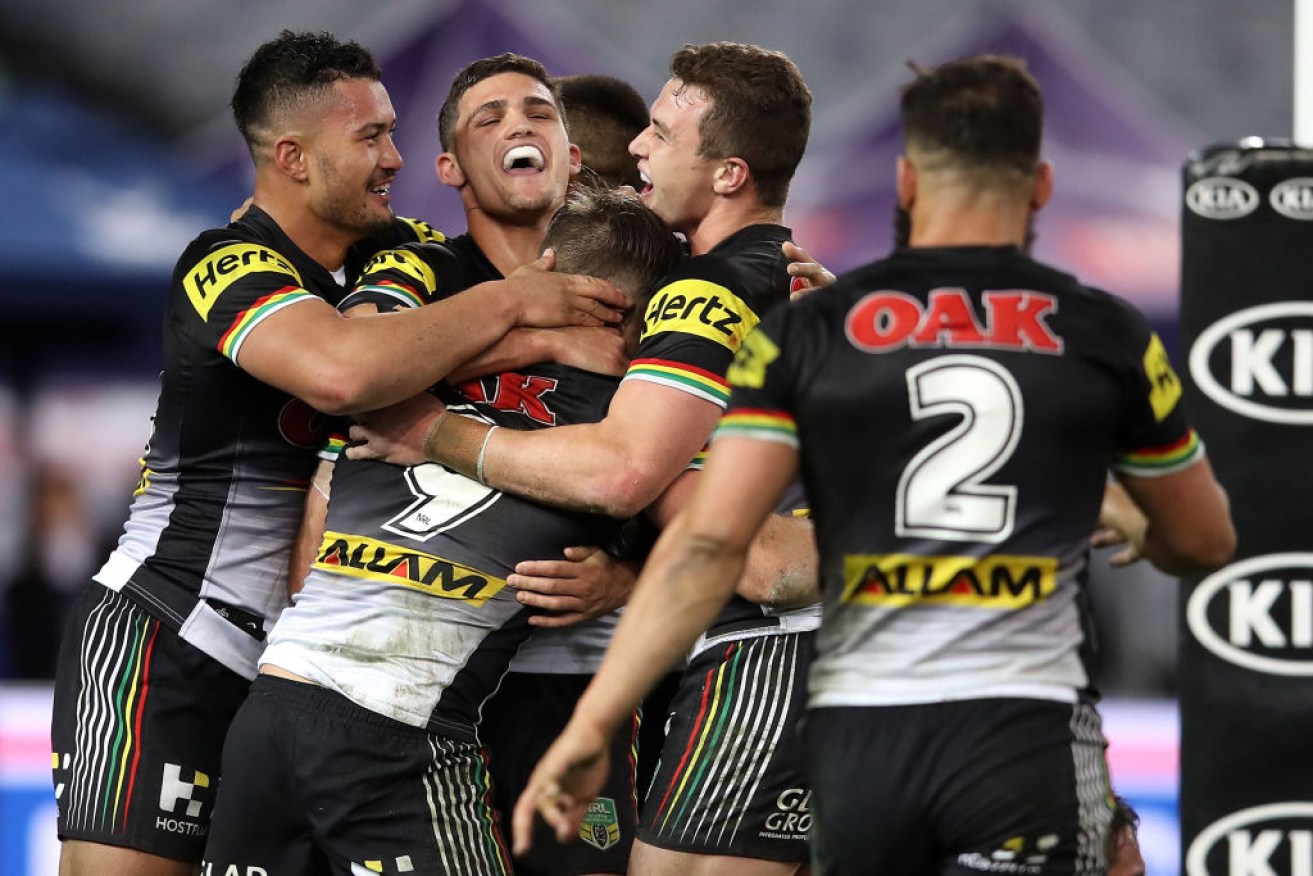 Mitch Rein celebrates a try with Panthers teammates. 