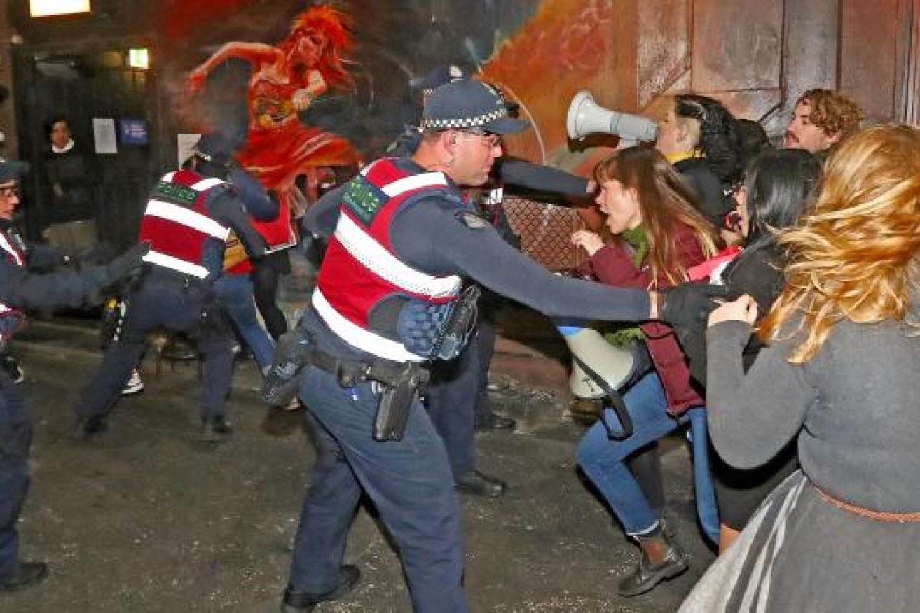 Protesters attempt to storm a side door at a Liberal Party fundraiser where Margaret Court was speaking.
