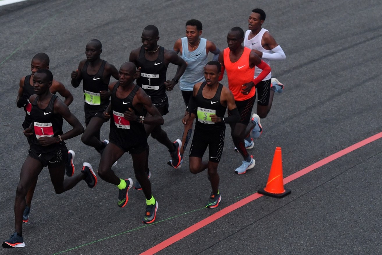 Eliud Kipchoge and his Nike 'teammates' run with the support of others.