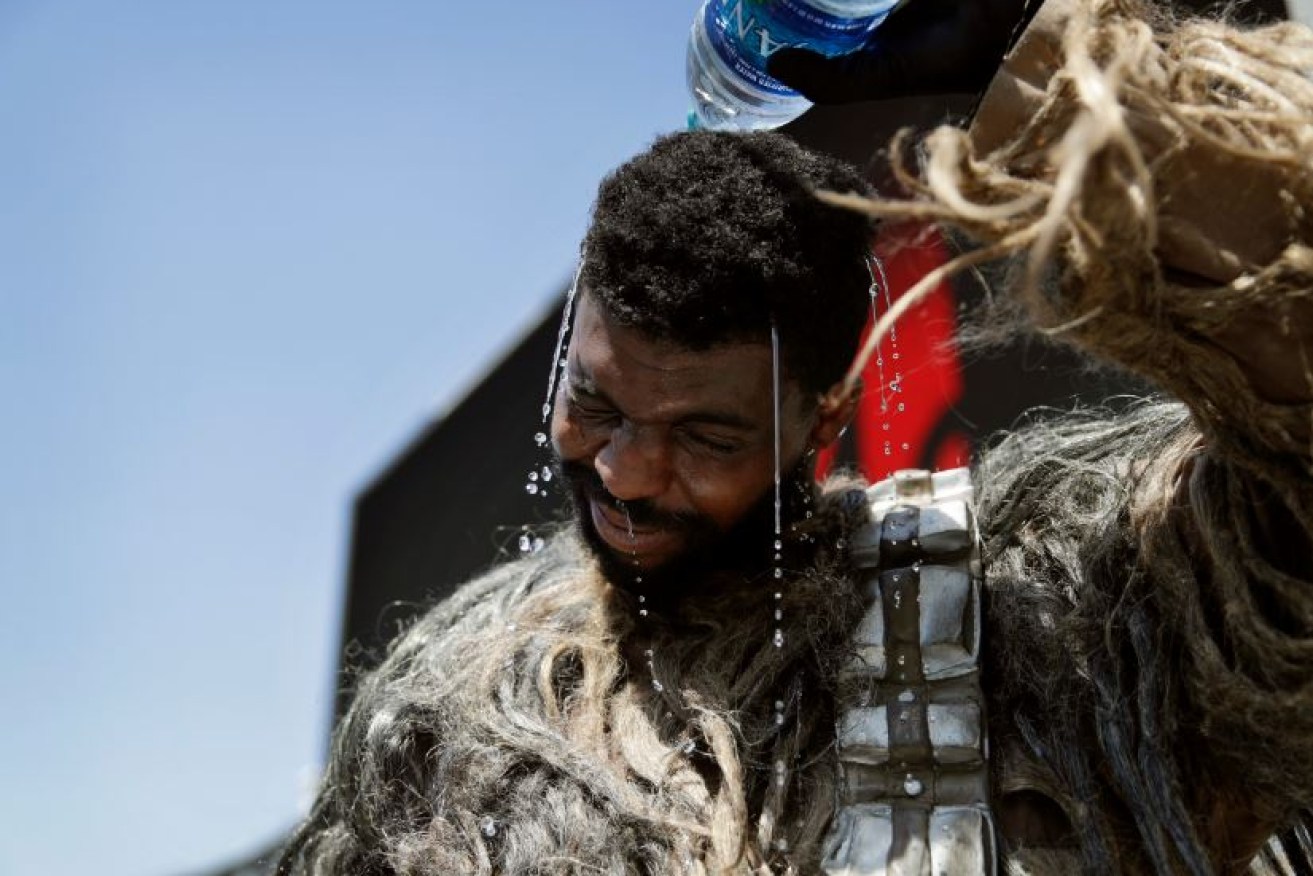 Xaviere Coleman takes a wet break from posing for tourists in his Wookie suit on the Las Vegas Strip.