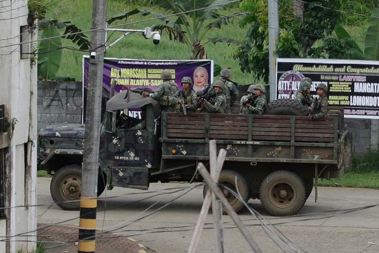 Guns at the ready, Philippines troops venture into the ISIS-held city of Marawi.