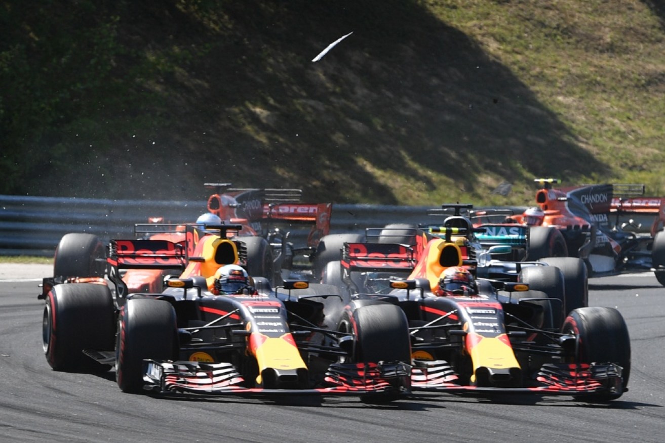 Australia's Daniel Ricciardo (L) and Red Bull's Dutch driver Max Verstappen come together on the opening lap of Hungarian Grand Prix in Budapest 