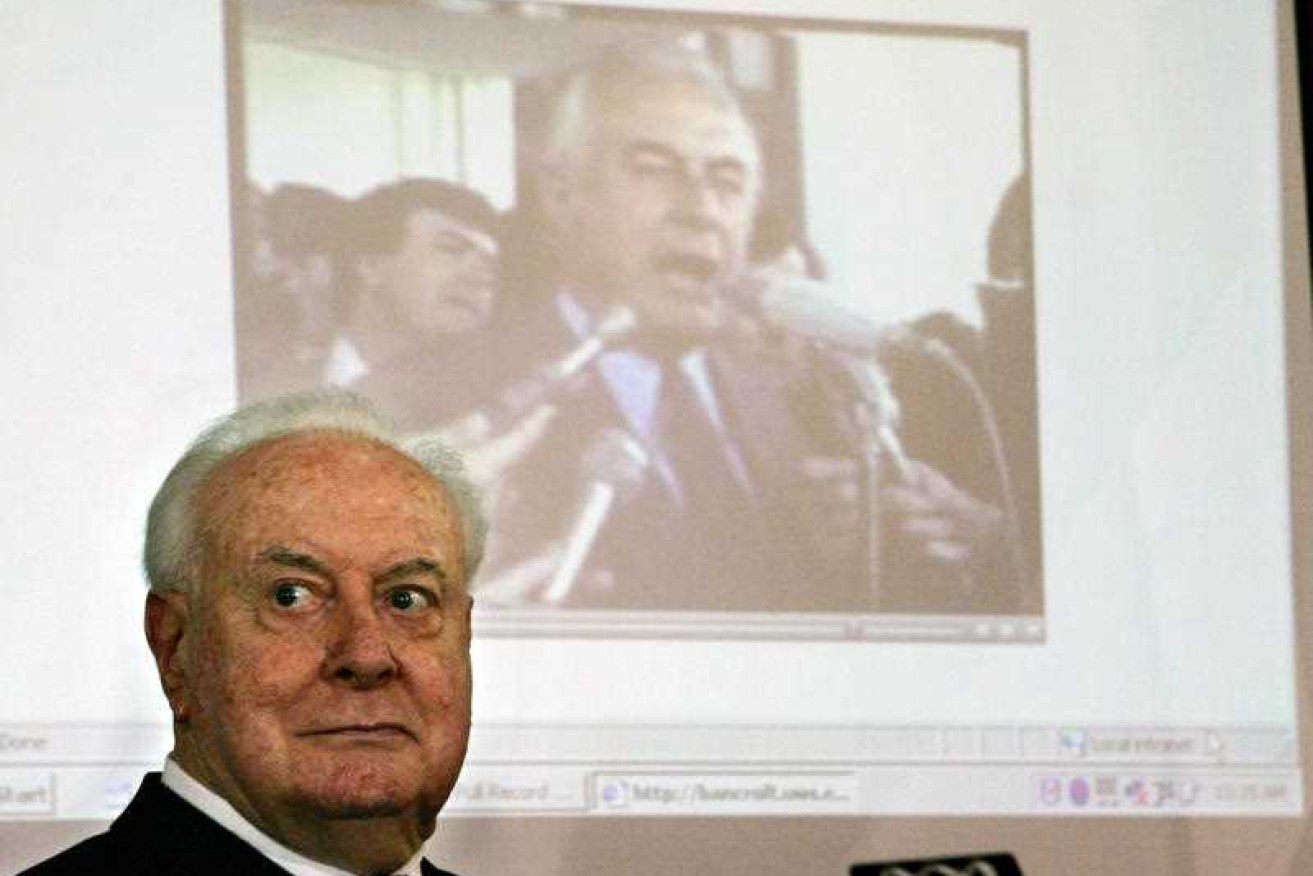 Gough Whitlam watches as a film clip of his resignation speech plays behind him at a 2005 lunch.