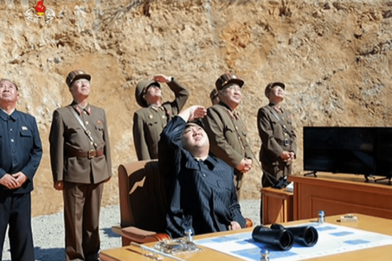 North Korean leader Kim Jong-un supervising a rocket launch.   