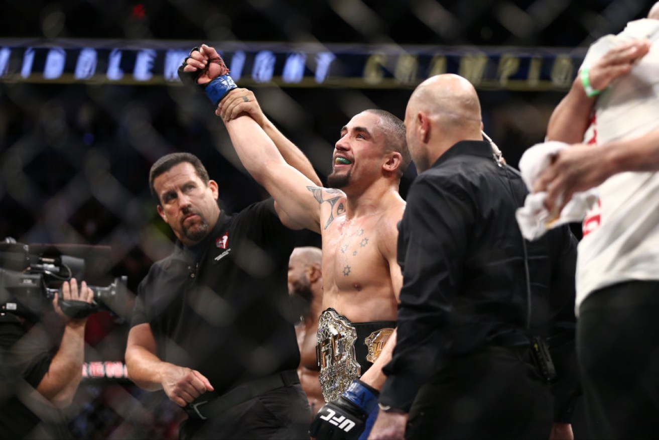 Robert Whittaker celebrates after his victory over Yoel Romero in their interim UFC middleweight championship bout.