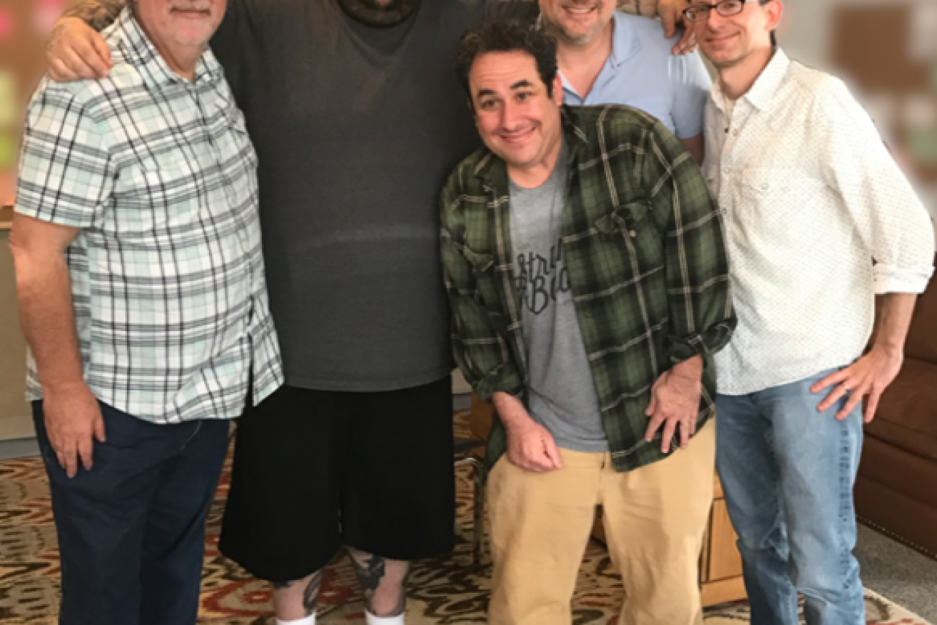 Briggs is pictured with Simpsons creator Matt Groening (far left) and collaborators