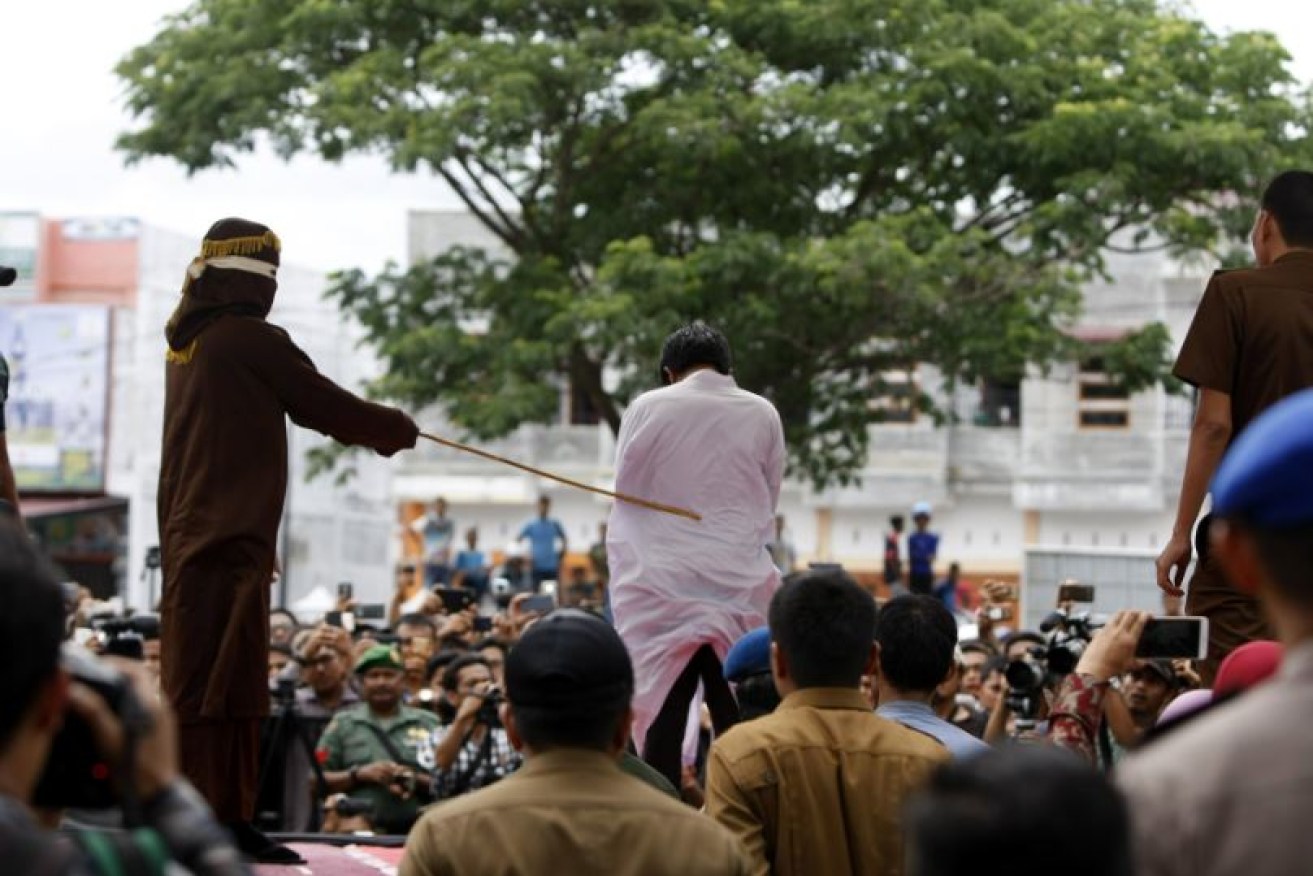 A gay man is whipped in public Aceh in March. 