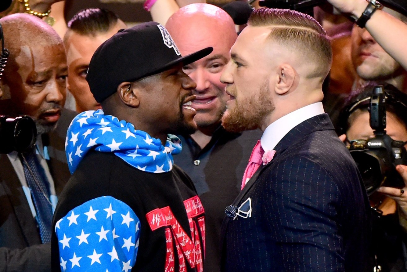 Floyd Mayweather Jr. and Conor McGregor face off at the press conference in Los Angeles.