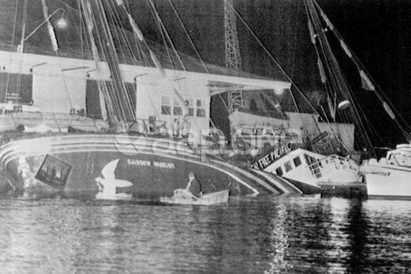 Greenpeace's Rainbow Warrior sits sunk at its Auckland dock after the 1985 bombing.