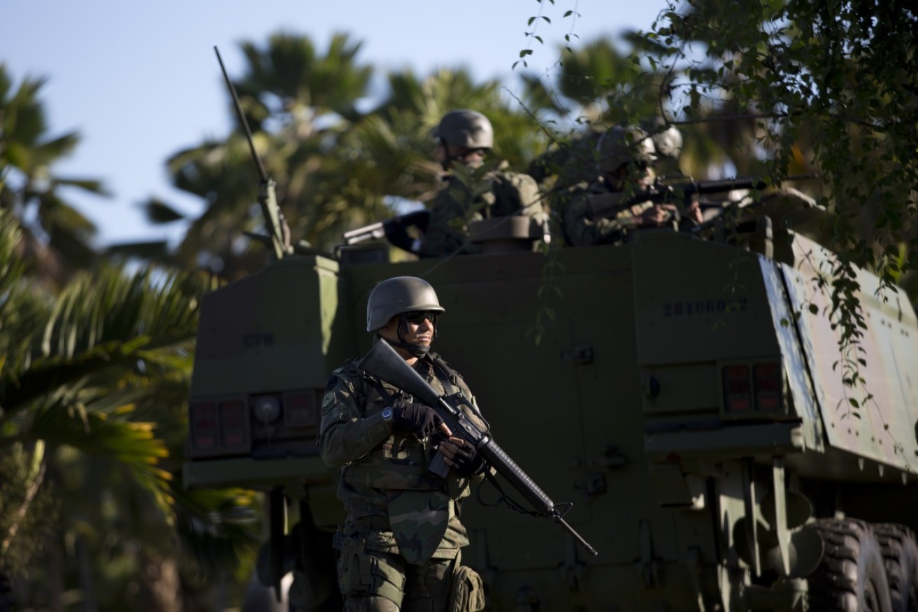 Navy soldiers in an armoured vehicle near the Santos Dumont Airport in Rio de Janeiro on Friday. Photo: AP/Silvia Izquierdo