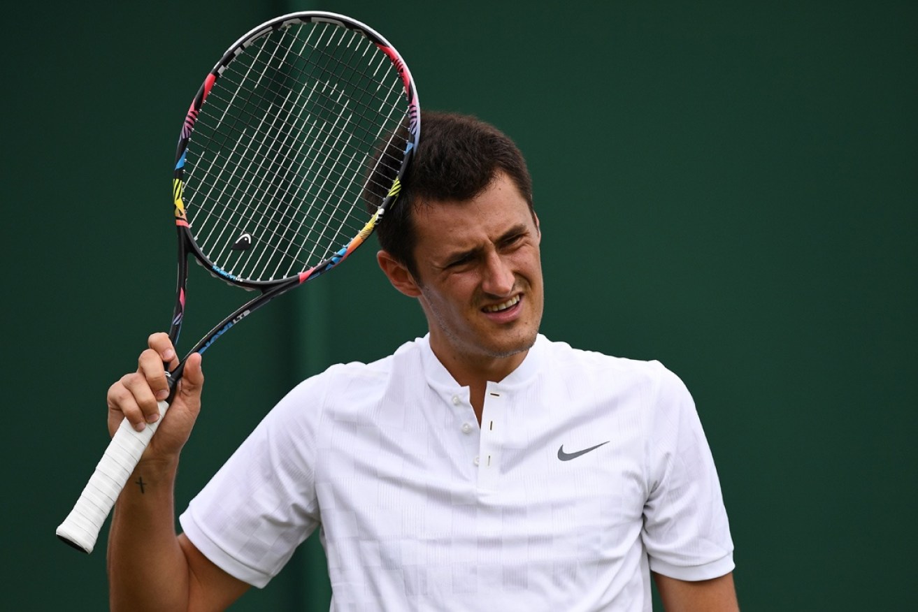 Bernard Tomic, who  admitted he faked an injury at Wimbledon, has been hit with a stiff fine.