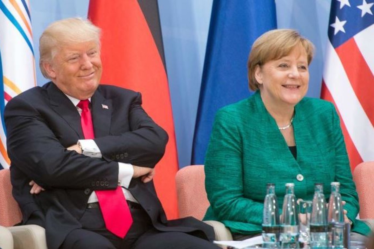 US President Donald Trump wears a smirk with Germany's Angela Merkel, who used the G20 summit to advance action on climate change.