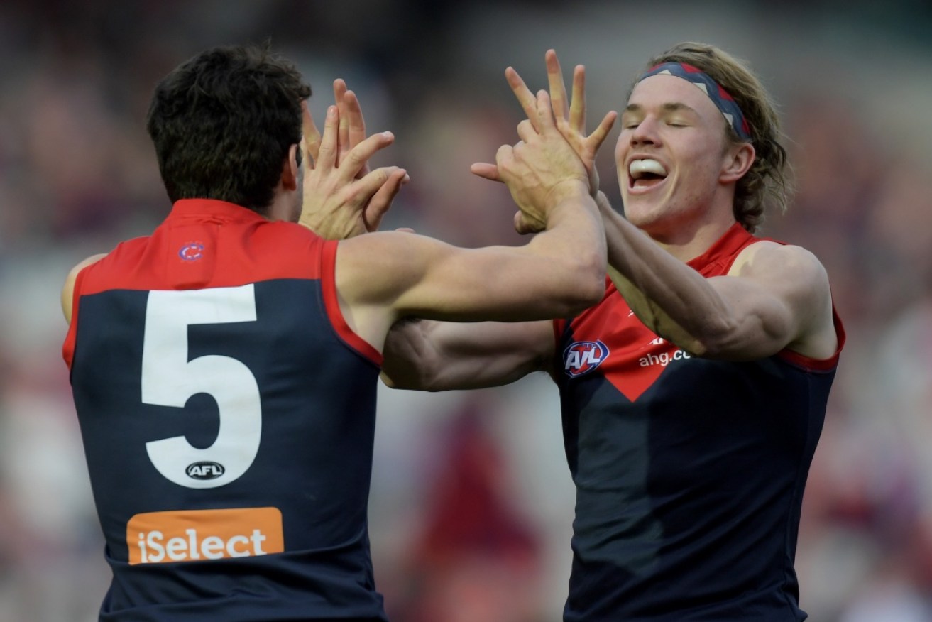 Jayden Hunt and Christian Petracca of the Melbourne Demons celebrate after a goal during the round 22