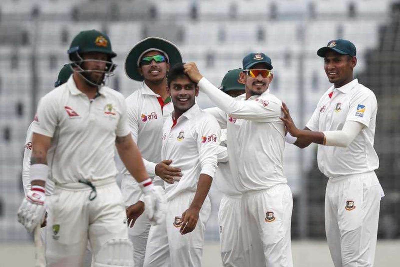 Teammates congratulate Bangladesh's Mehedi Hasan Miraz after the dismissal of Australia's Matthew Wade.