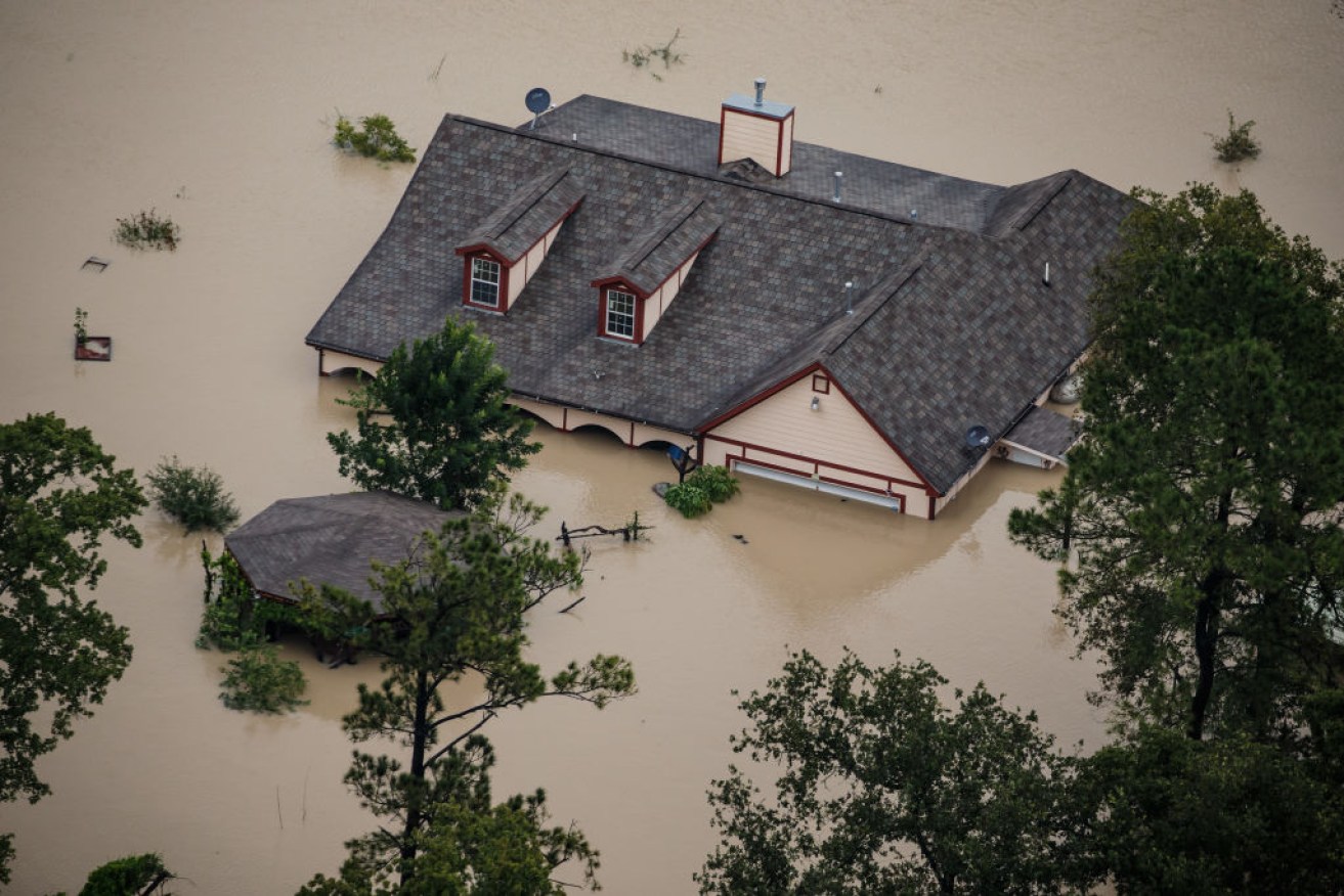 A house sits completely submerged in flood water in the wake of Hurricane Harvey in Houston, Texas.