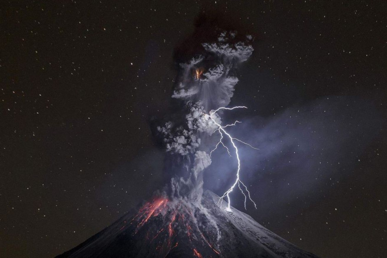 A powerful eruption illuminates the slopes of Mexico's Colima Volcano on December 13, 2015.