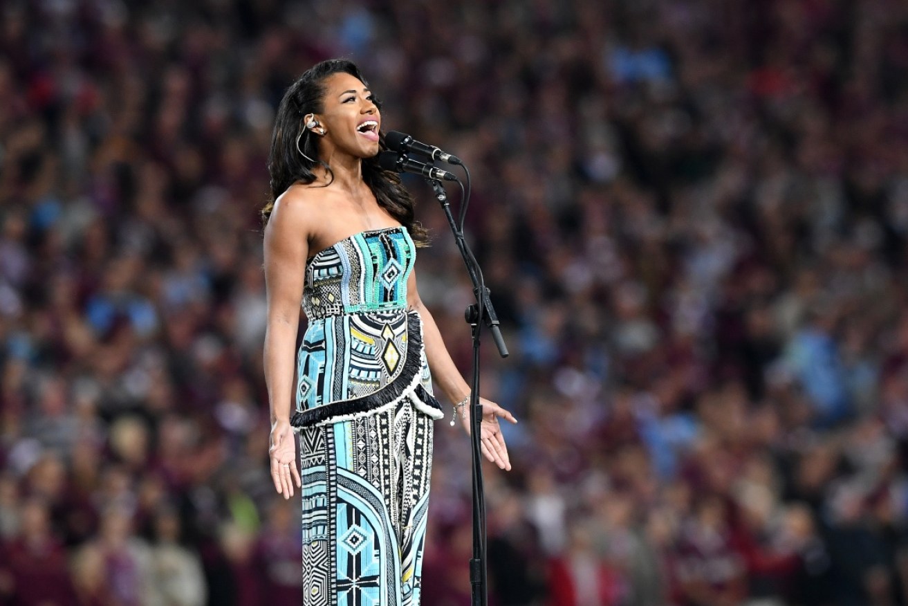 Paulini, pictured singing  the National Anthem prior to a State of Origin Game in Brisbane last month. The singer faces up to seven years jail for paying an official for an unrestricted licence