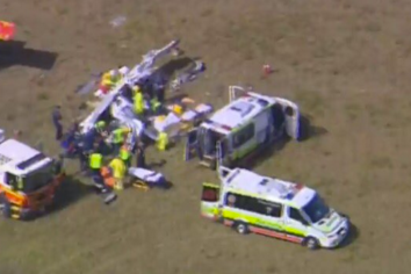 Ambulance paramedics are on scene treating two people trapped inside a light plane in Caloundra. Photo: Twitter
